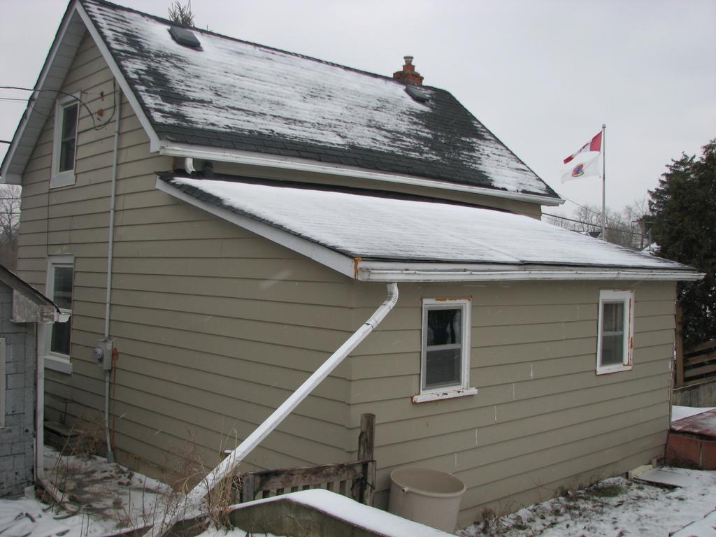 I 1-10 6. Existing House Description The house is a small 1 ½ storey building approximately 24 feet wide by 16 feet deep, with a one storey tail that is approximately 19 ½ feet wide by 10 feet deep.