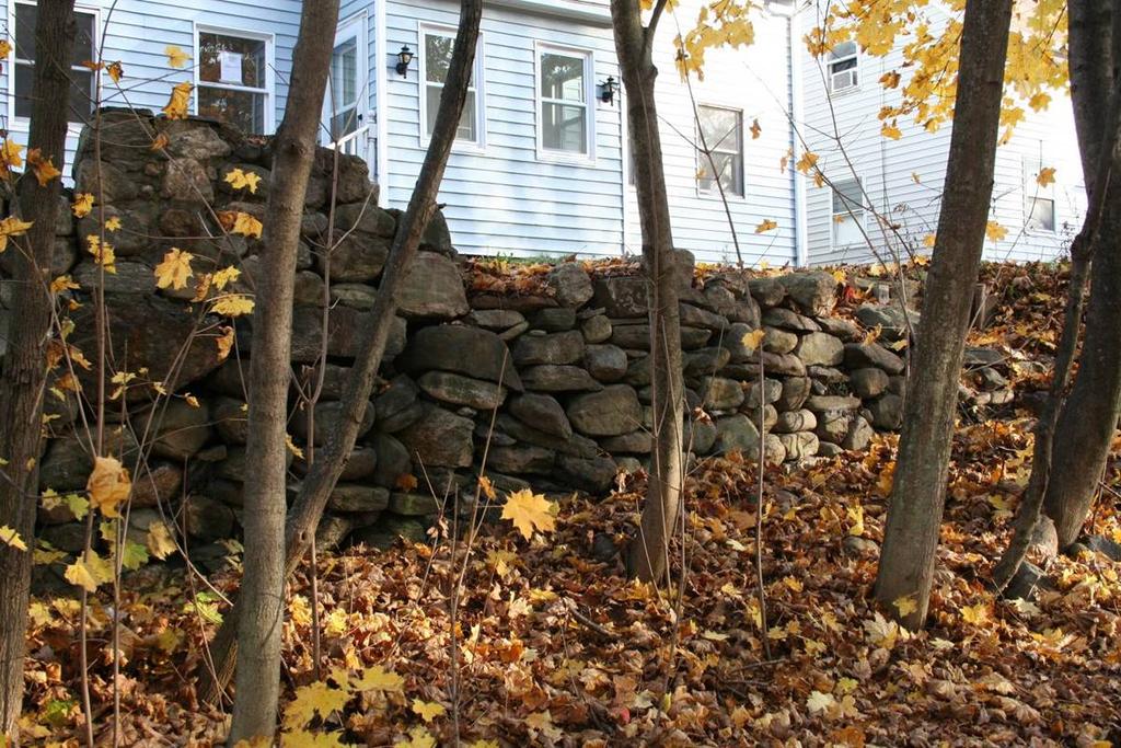 A portion of the fieldstone retaining wall forming the terrace