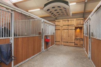 apartment, two detached barns with a total of 13 horse stalls, an outdoor