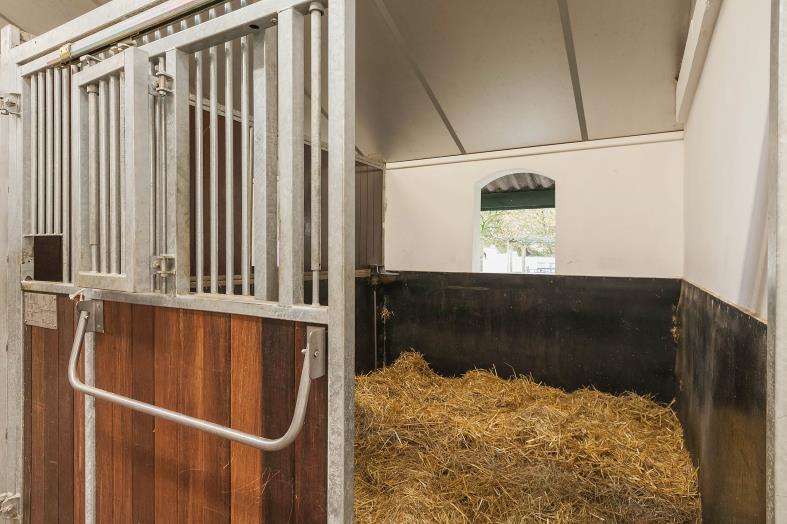 The five stalls have hardwood and galvanized rotatable fronts with a sliding door.