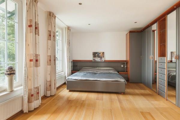 The spacious master bedroom is finished with a wooden