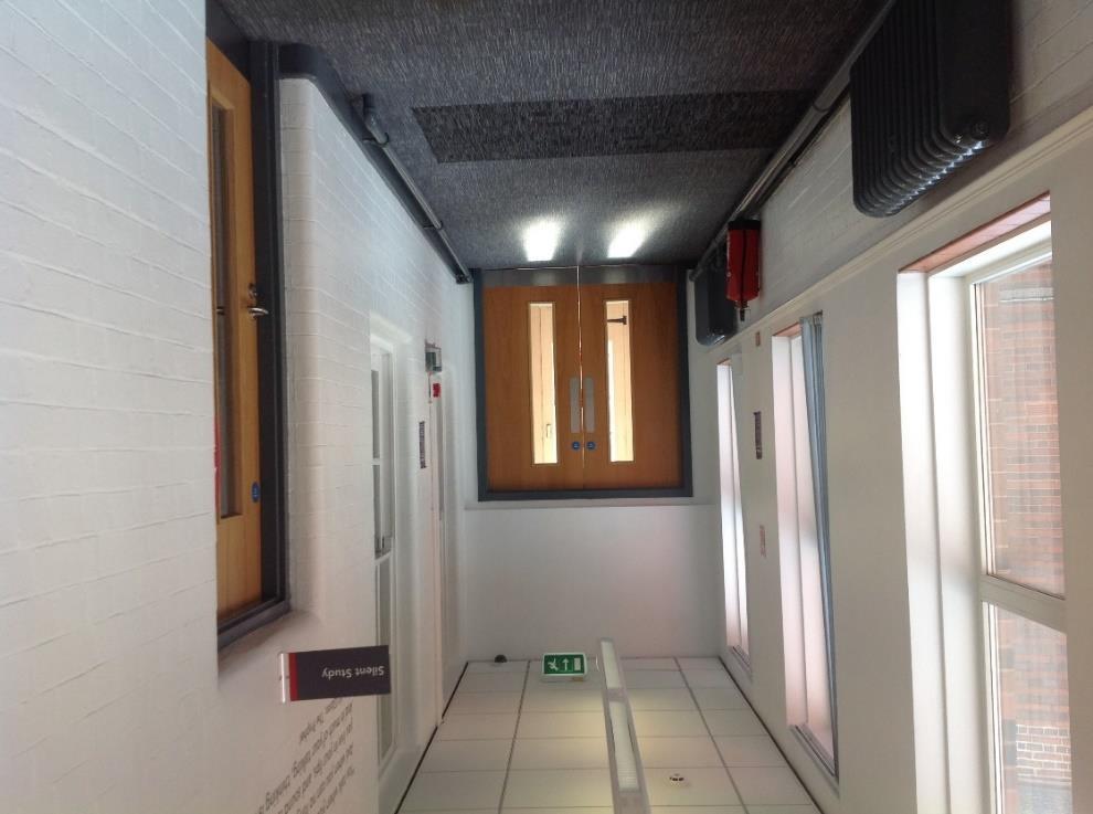 Turn left onto the corridor to access the toilets, which have noisy hand dryers that may start