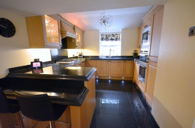 base and drawer units as well as a contrasting dark granite work surface with
