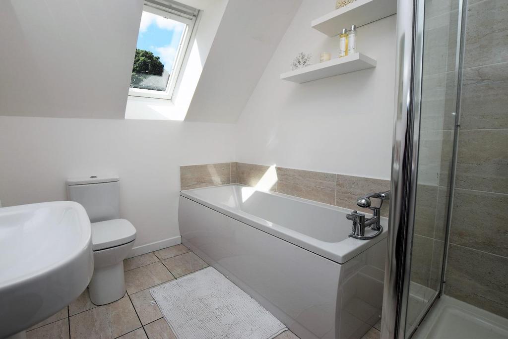 FAMILY BATHROOM Approx. 2.68 m x 2.01 m The modern family bathroom is fitted with a four piece suite comprising of a pedestal wash hand basin, a WC, a bath and a shower cubicle.