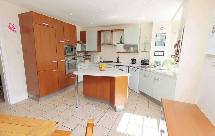 The garden level has a fully fitted dining kitchen with central island unit and access to rear garden, generous family room/ games room with 3 section bay window and downstairs W. /. loakroom.