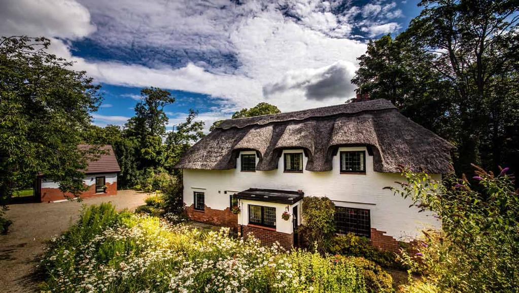 Enchanting Arts and Crafts thatched cottage with
