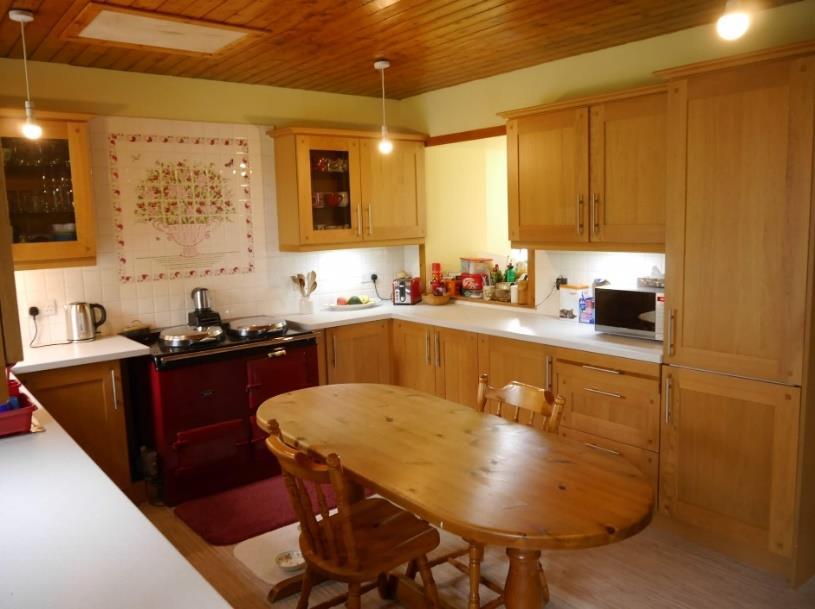 Kitchen/Diner: Linoleum flooring, 2 windows, modern fully fitted kitchen with worktops and tiling above, stainless steel double sink and drainer, Aga heats the domestic hot water, integral