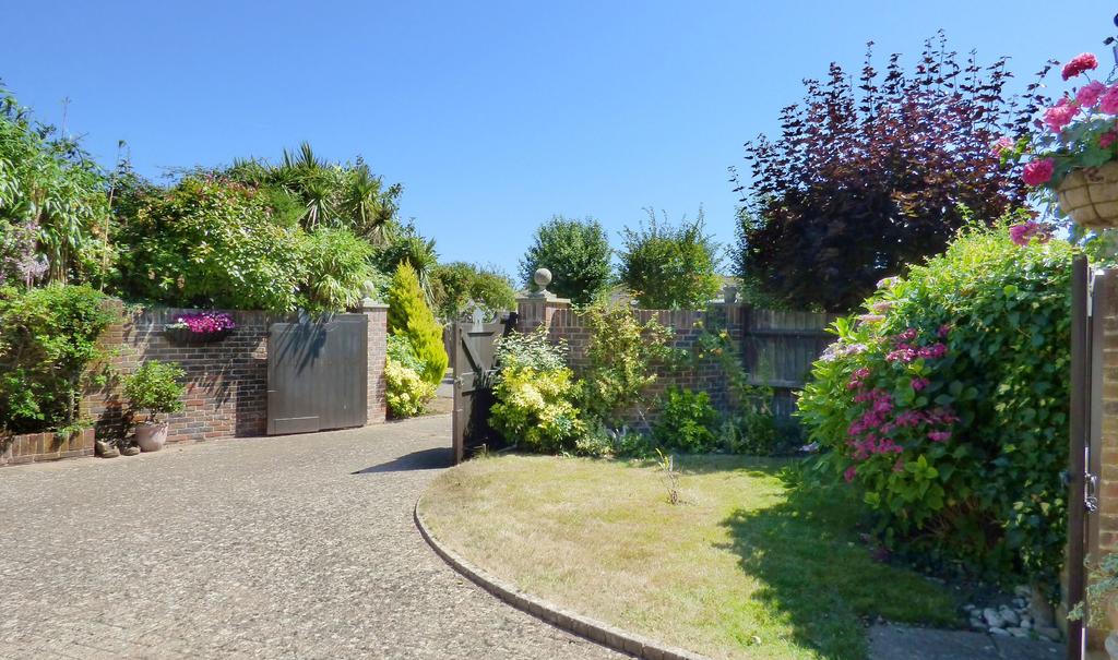 The gardens are enclosed by walling and fencing with established shrubs and trees providing screening from neighbouring properties.