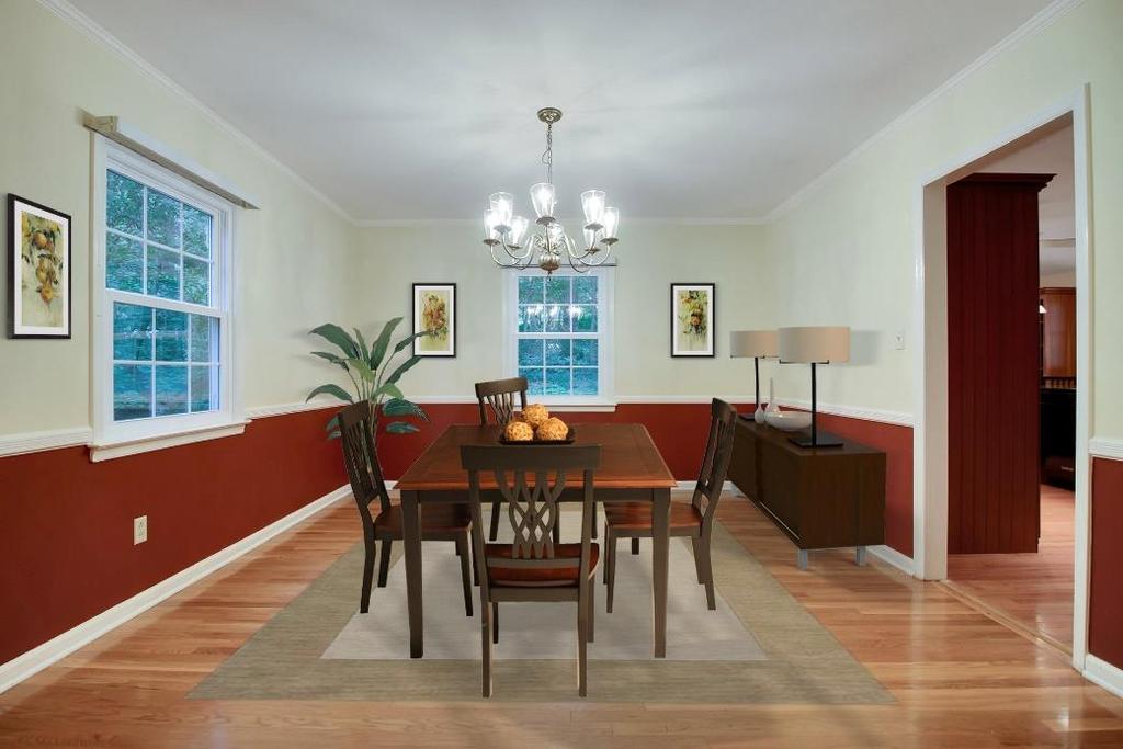 The crown molding and hardwood floors found in the Living room continue in the bright and elegant Dining Room.