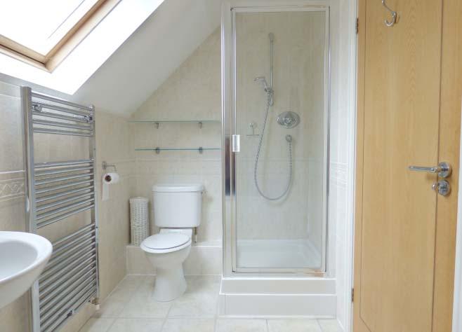 cubicle with fitted shower unit, close coupled w.c. and pedestal wash hand basin, electric