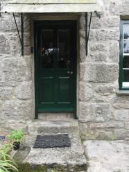 Hall. Slate canopied, part glazed front