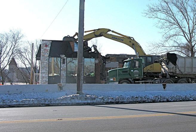 Above photos show some of the early work taking place. The razing of a group of homes along McFarlan Street west and the razing of Traveler s Diner.
