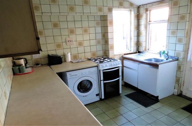 90m (9' 6") into recess The kitchen area includes an array of wall and floor cabinets finished in a white colour with contrasting laminated work surfaces and an additional cabinet inset with a