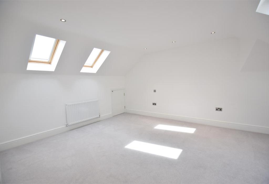 BEDROOM THREE Bedroom three is a light and airy room with two sets of two skylight windows to the front and rear elevations There are two central heating radiators, under eaves storage and inset
