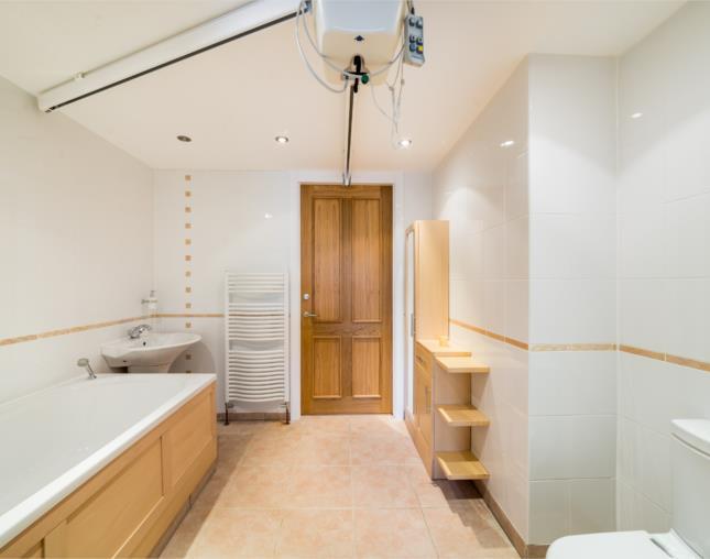 GROUND FLOOR BATHROOM 10' x 8' 3'' (305m x 244m 091m) The generous proportioned ground floor bathroom has been adapted for mobility There is a low level wc with push button flush, pedestal wash