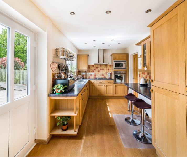 KITCHEN 14' 8'' x 8' (427m 244m x 244m) The kitchen features a range of fitted wall and base units with shaker style cupboard fronts and roll edge work surfaces over incorporating a one and a half