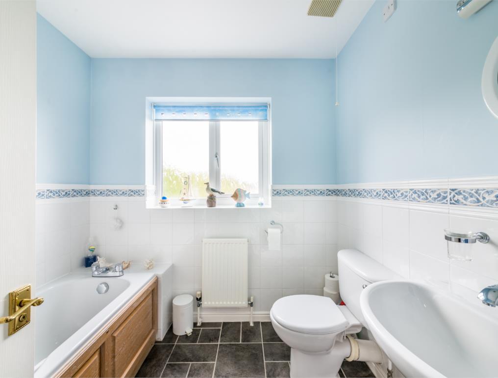 6' 4'' x 7' 5'' (183m 122m x 213m 152m) The house bathroom features a white three piece suite comprising of a panelled bath with electric shower over and shower guard, pedestal wash hand basin and