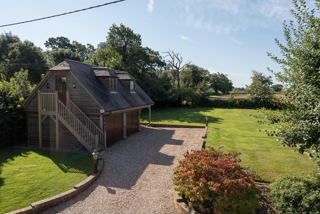 in brief points Coombe Cottage is a detached 4/5 bedroom country house extending to a total of 4924 sqft and standing in a generous plot in excess of two acres with stunning views across open