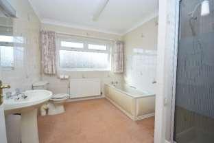 - 7 - FAMILY BATHROOM Spacious bathroom consisting of a panelled bath, low flush WC, pedestal hand wash basin and shower cubicle. Fully tiled walls. Shaver point and light. Coved ceiling.