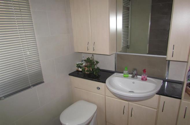 03m (6' 8") Three piece suite comprising: panelled bath with electric shower over and shower