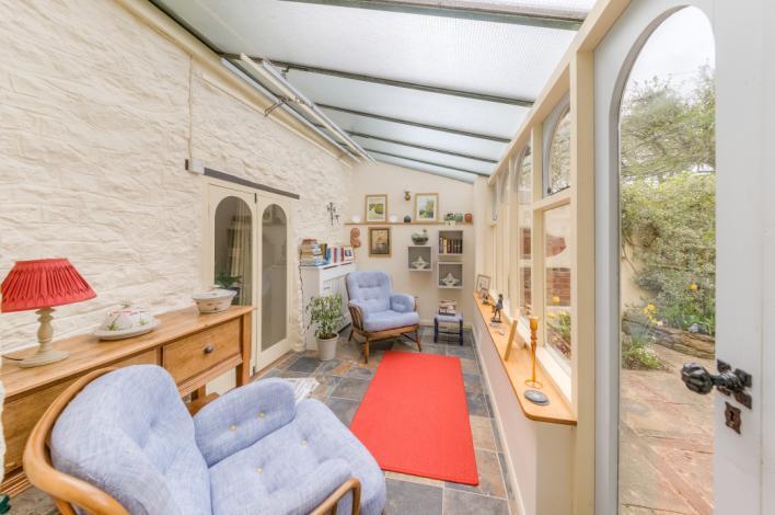 From the conservatory and study; doors lead to a further tranquil secluded courtyard garden with raised beds and enclosed by walls and fencing.