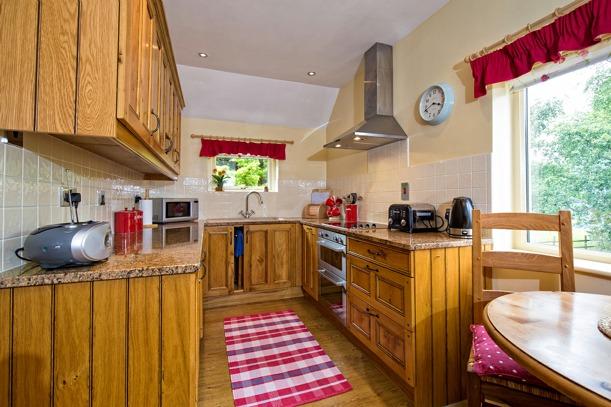 The Dining Kitchen has a laminate floor, dining area space and a range of handmade base and wall cupboards, granite