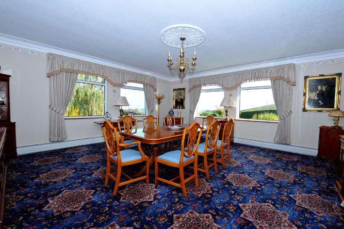 FORMAL DINING ROOM: 19 3 x 18 9 (5.87m x 5.72m) Corniced ceiling. Wall light wiring. Centre rose. Double windows overlooking beautiful front gardens, greens fields towards Newtownards.