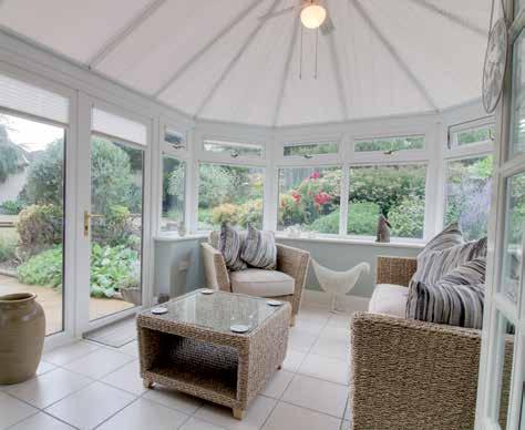 Carpeted, curved steps lead to the raised floor area with an abundance of light from the two windows and the French doors that open out into the rear garden.