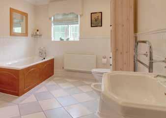 With an attractive, tiled floor it contains two heated towel rails, extractor fan, a large shower, bath,