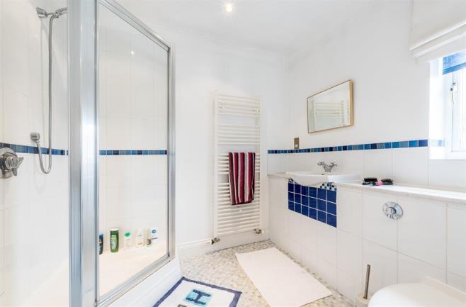 UTILITY ROOM With a door leading from the kitchen and having a range of wall and base units, work surfaces with tiled splash back, stainless steel sink and