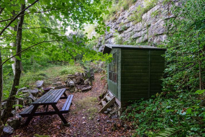 Stepped pathways wind up through the sloping woodland and coppice to several sitting areas that enjoy spectacular views and splendid evening sunsets, damson trees provide a wealth of fruit and when