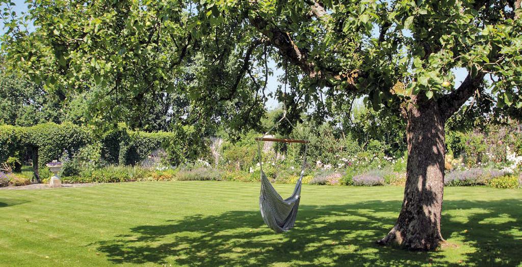 GARDENS & GROUNDS There are two principal areas of formal garden: a lawn with wild flower meadow extends away from the house to the south west, to one side of which is a handsome oak, the