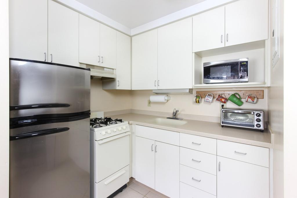 stocked with basic kitchenware, Cable TV, wall mounted flat screen television in room.