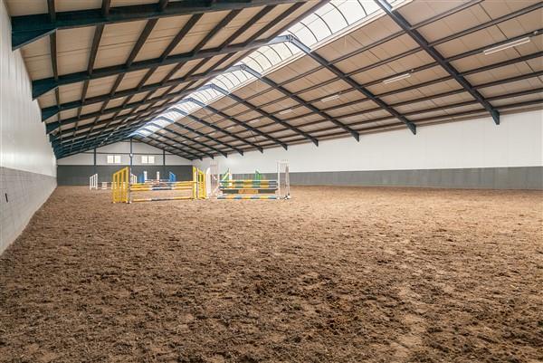 The fully insulated riding hall is constructed with steel trusses and has a