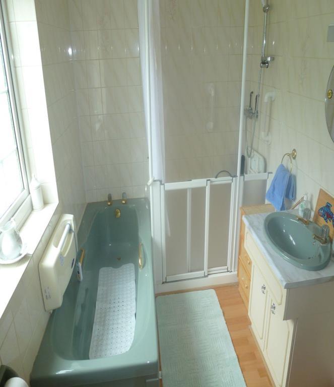 Door leads through to: - EN-SUITE BATHROOM: Comprises of a four piece suite to include panelled bath, separate shower unit, wash hand basin inset vanity unit and WC.