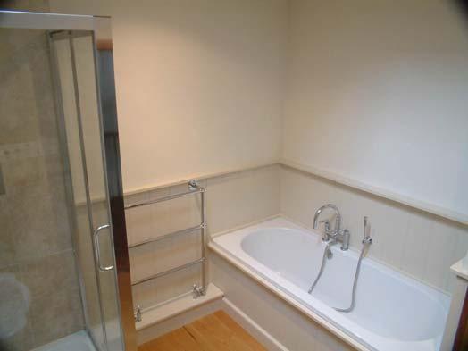 Pedestal basin. Tiled shower cubicle with power shower.