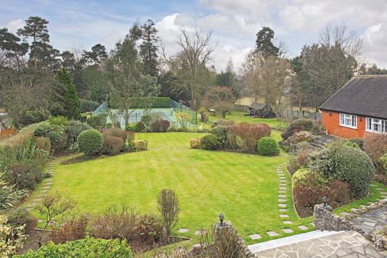 To the rear of the property is a substantial paved terrace, providing a perfect seating area overlooking the gardens.