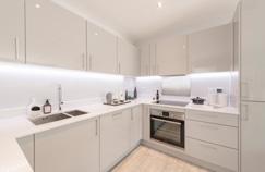 Fully fitted kitchen in satin gloss by Manhattan Kitchens with integrated appliances: - Multi-function AEG double oven - Extractor hood - AEG ceramic hob with glass splashback - AEG fridge/freezer -