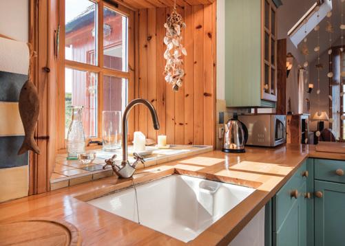 kitchen has ample base and wall units with a Belfast style sink, wooden