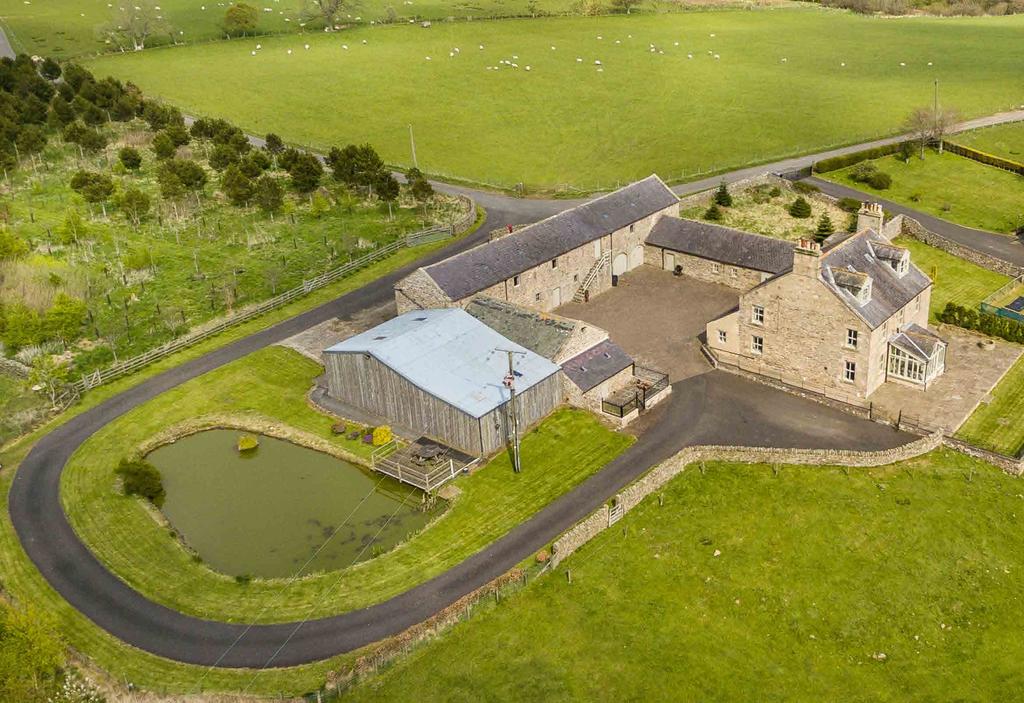 A substantial double-fronted Northumbrian farmhouse set in an elevated