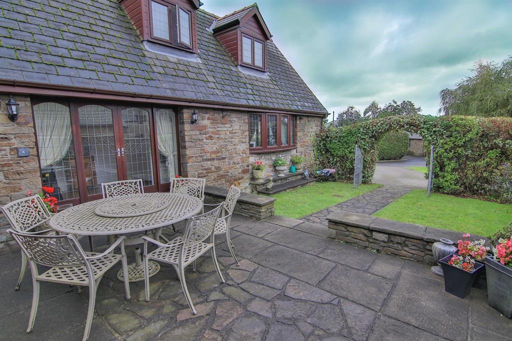 The lovely and well presented accommodation comprises of four bedrooms, large lounge with feature fireplace and french doors, sitting room, the bespoke fitted kitchen has a matching dresser unit and