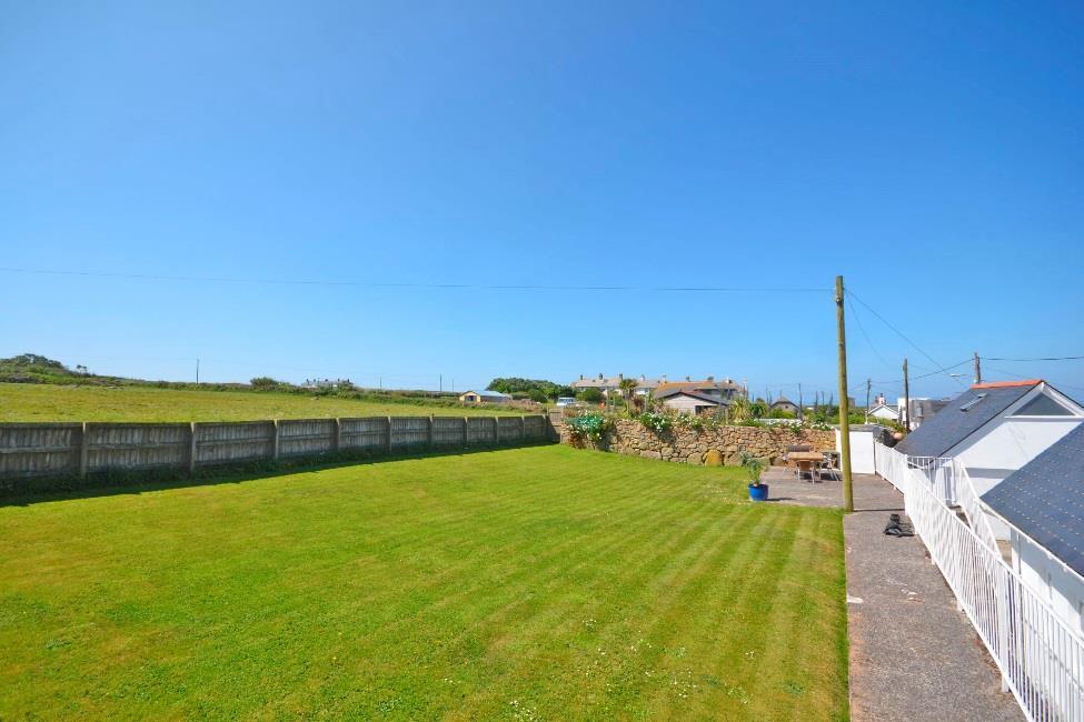 Outside: parking for 2-3 cars, two sea facing terraces, large level lawned garden backing onto fields, store.