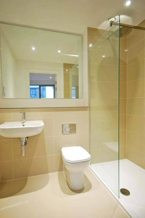 Double walk-in shower unit with mixer tap, overhead shower and glass screen. Low level wc with dual flush.