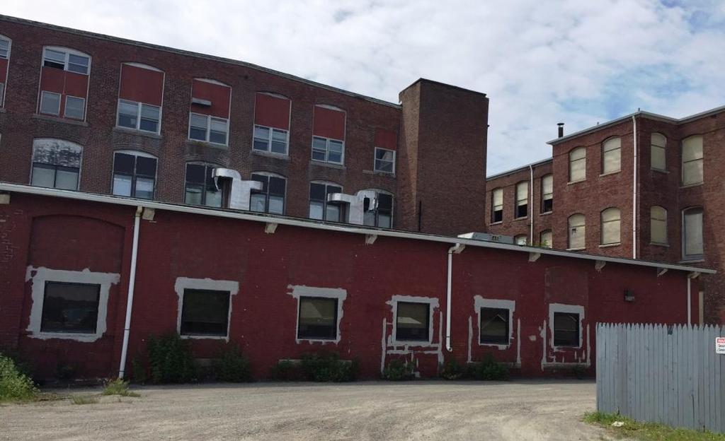 vacant mill building to accommodate parking for a new tenant and to allow for further investment and redevelopment of the existing portions of the mill site.