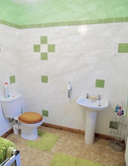 Ensuite: comprising; low flush WC, fully tiled walk in shower