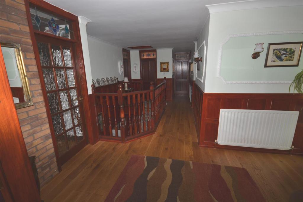 Ground Floor Storm Porch Entrance Hall Spacious entrance hall with oak flooring and panelled walls. Two radiators.