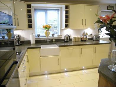 leading into the breakfast kitchen Porcelain tiled flooring with under floor heating, superb range of contemporary style kitchen base units in a gloss finish with brushed stainless steel handles and