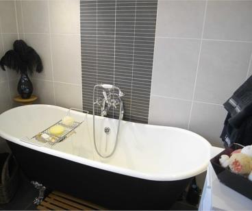telephone style shower attachment, granite tiled flooring, quality tiling from floor to ceiling