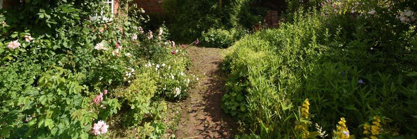Brick pathways meander through the gardens where there are extensive flower and shrub beds.