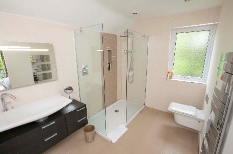 storage and mixer taps, mirrored wall cabinet with built in storage, fully tiled walls, ceramic tiled floor,